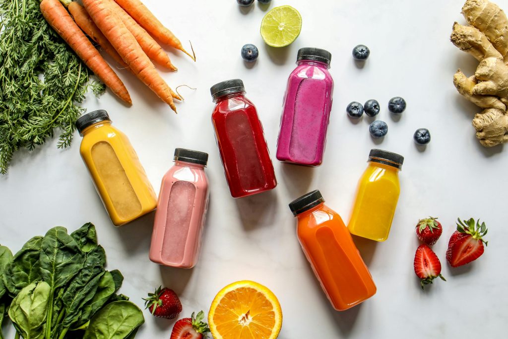 Colorful assortment of organic juices with fresh ingredients for a healthy lifestyle.